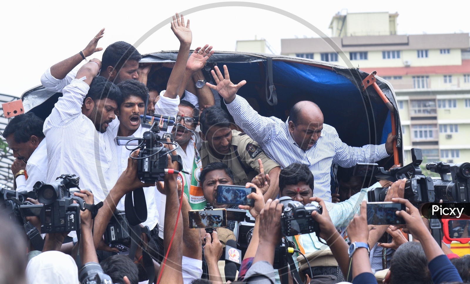 men chant slogans against Telangana Chief Minister, K Chandra Shekhar Rao after being arrested by Police