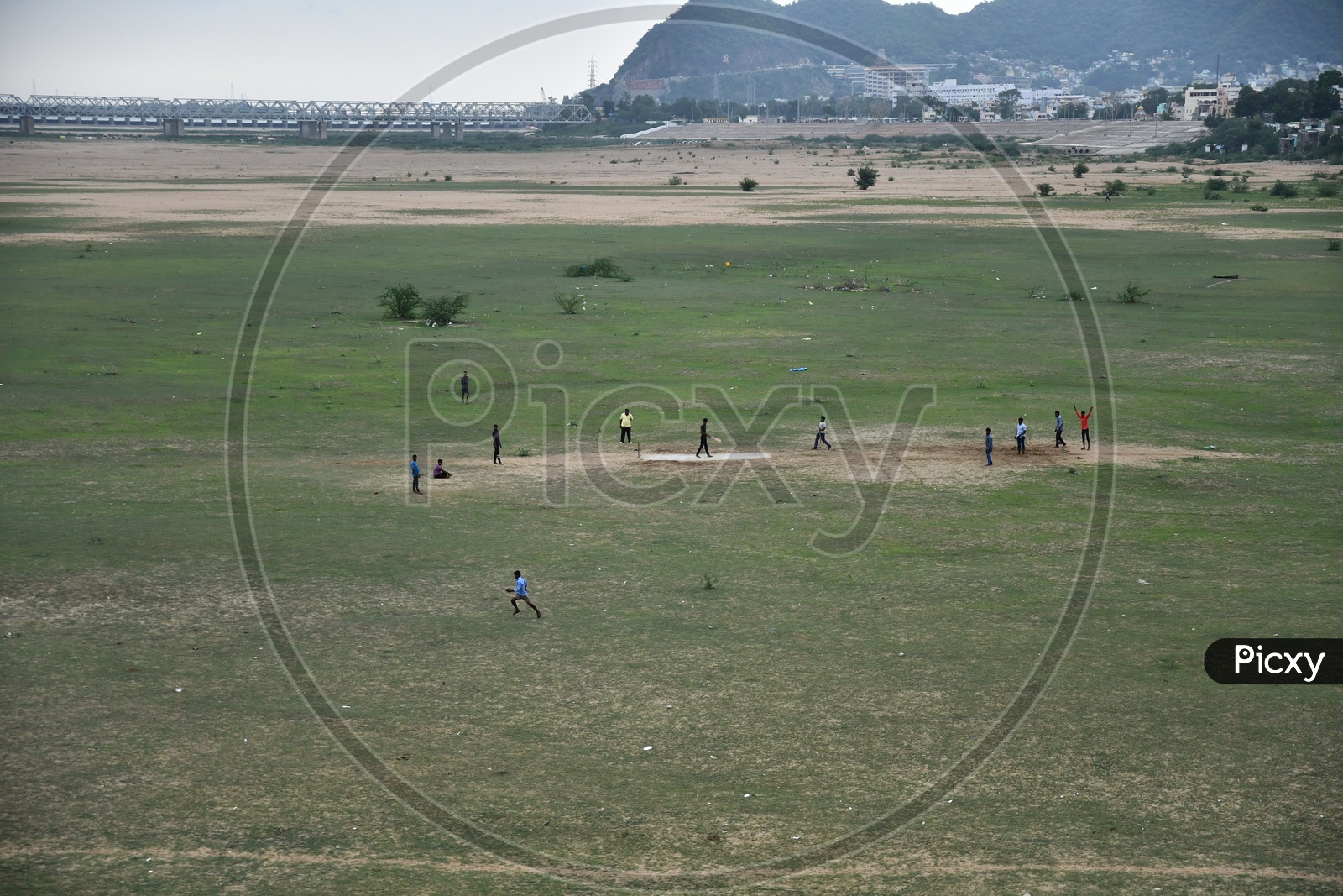People Playing Cricket on Sand in Krishna River