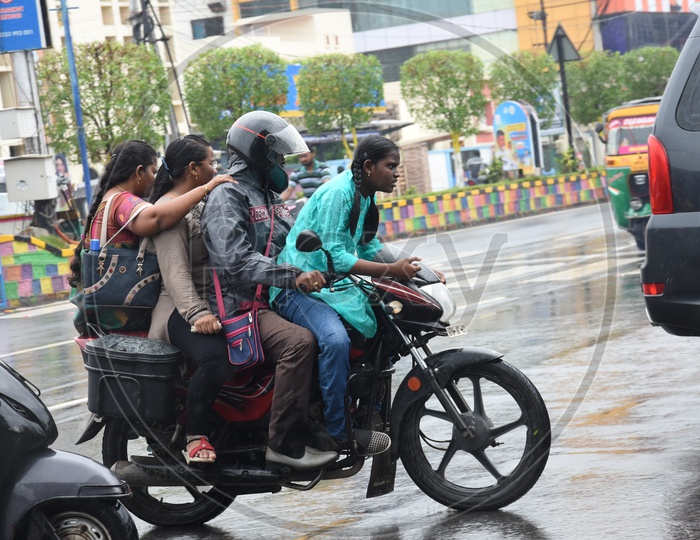 Unidentified Indian Family on Bike while raining