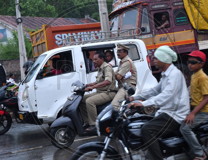 Unidentified Police on Two Wheeler in Traffic without wearing Helmet