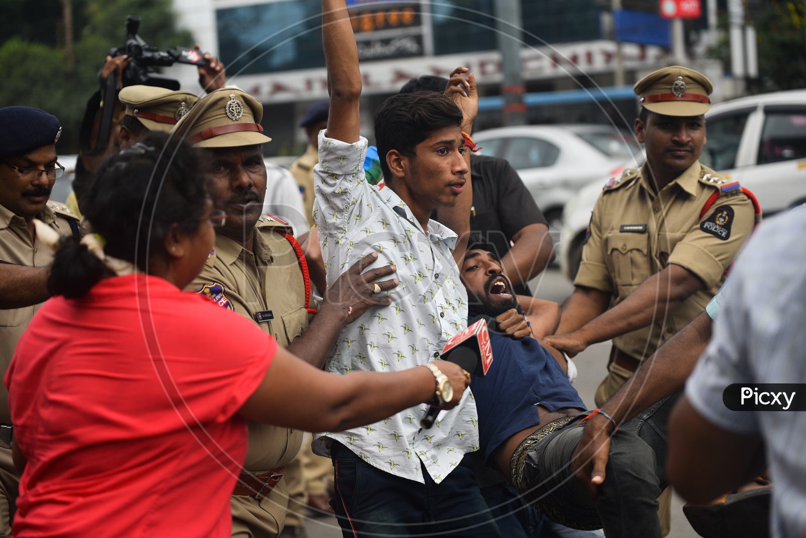 Image of youth being detained into a van by Telangana Police as he ...