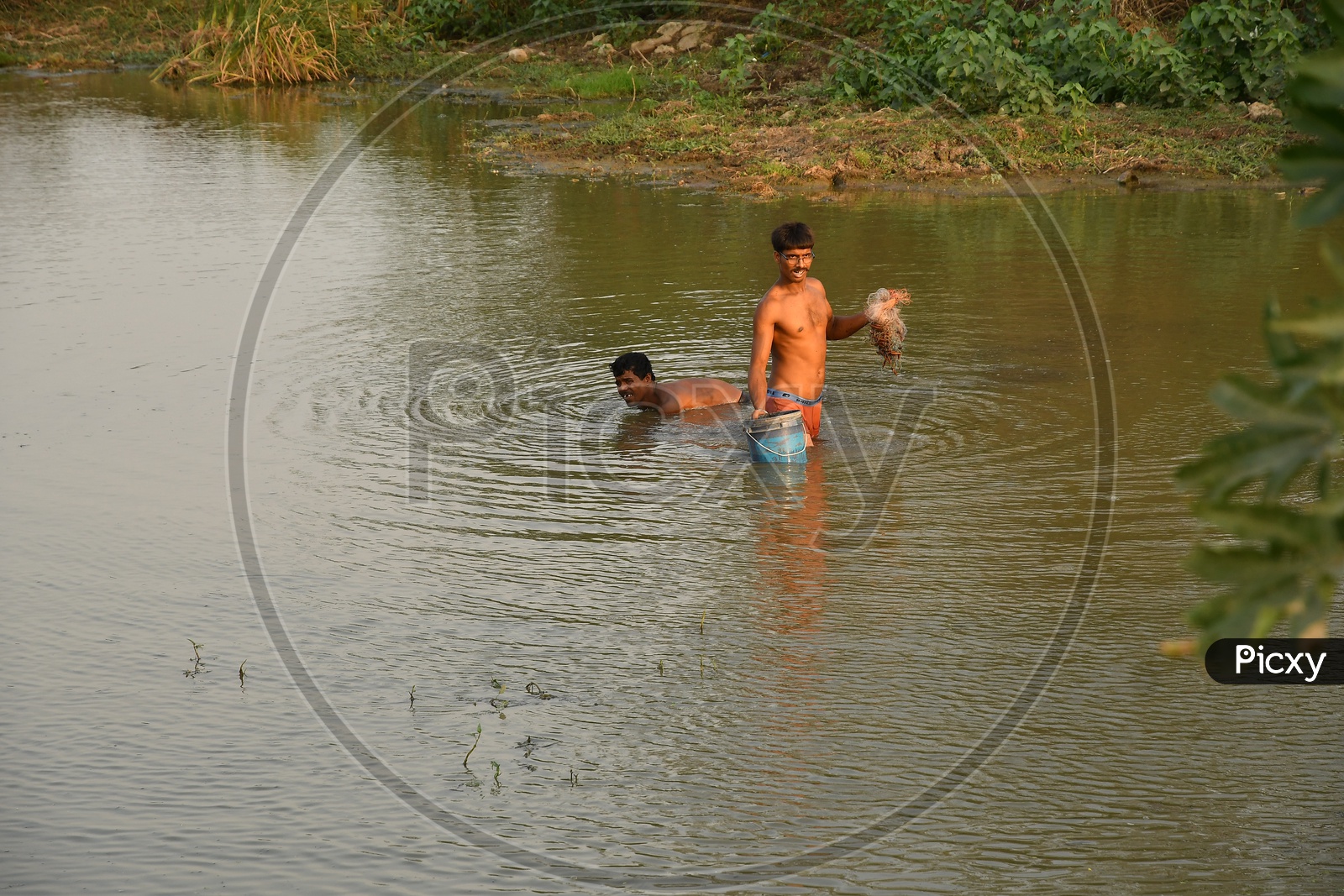 Indian Fishermen with cast nets in the lake