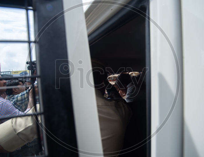 A congress party worker being detained into a vehicle by Telangana Police as he protests at Pragathi Bhawan Gherao
