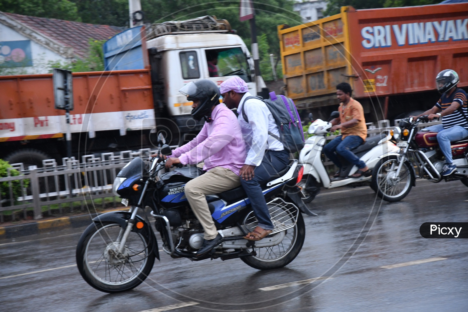 Two Wheeler Commuters Commuting in Rain