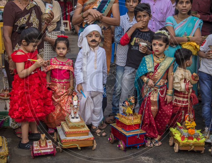 Image of children's celebrating the Pola festival by decorating