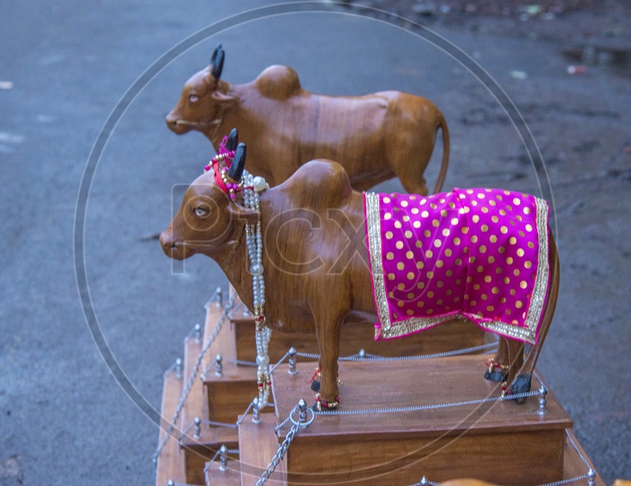children's celebrating the Pola festival by decorating and exhibiting a wooden bull