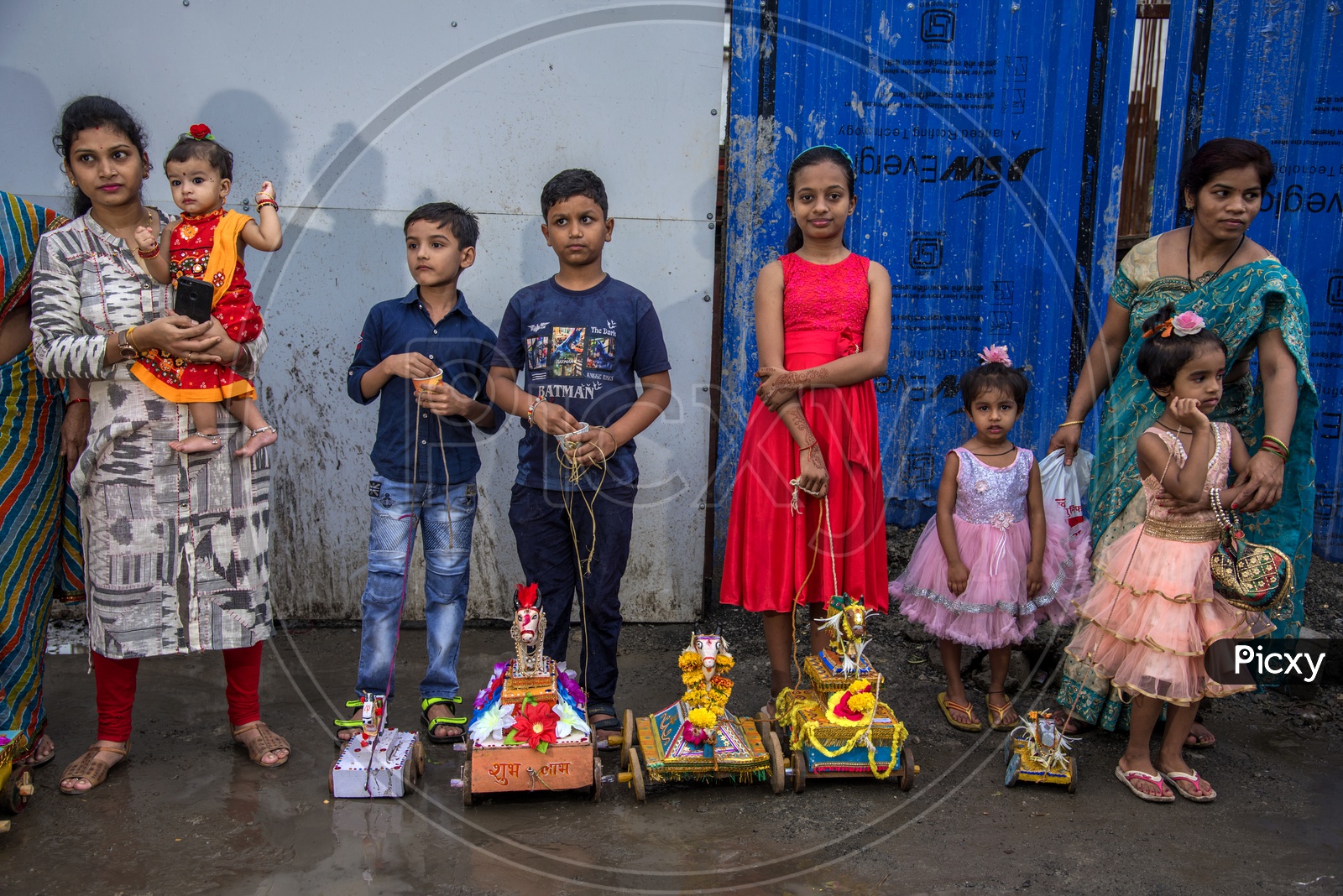 Image of children's celebrating the Pola festival by decorating