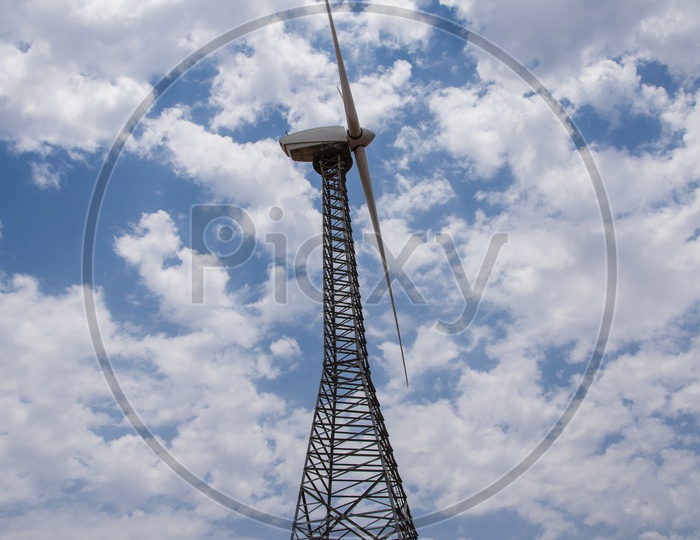 Windmills With Bright Blue Sky and Clouds Background
