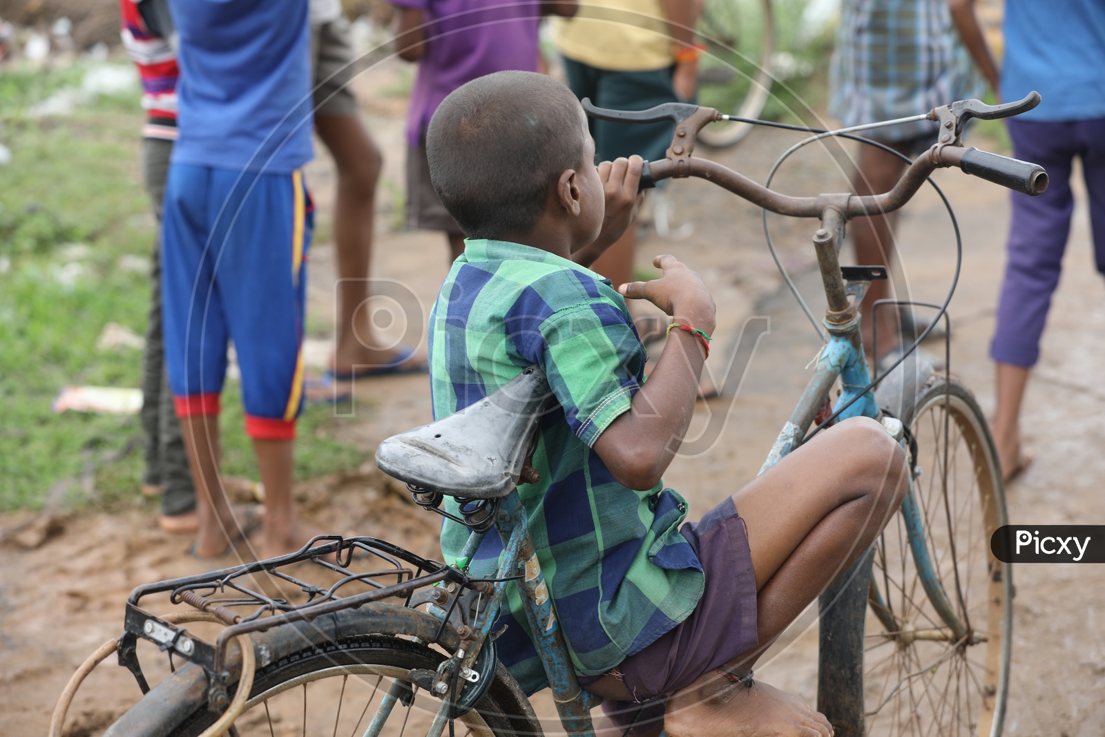 Indian Kid sitting on a bicycle