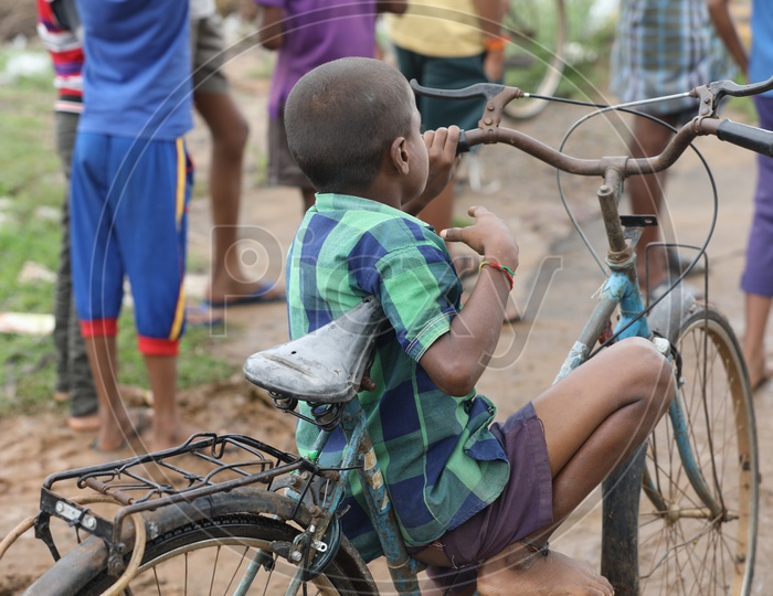 Indian Kid sitting on a bicycle