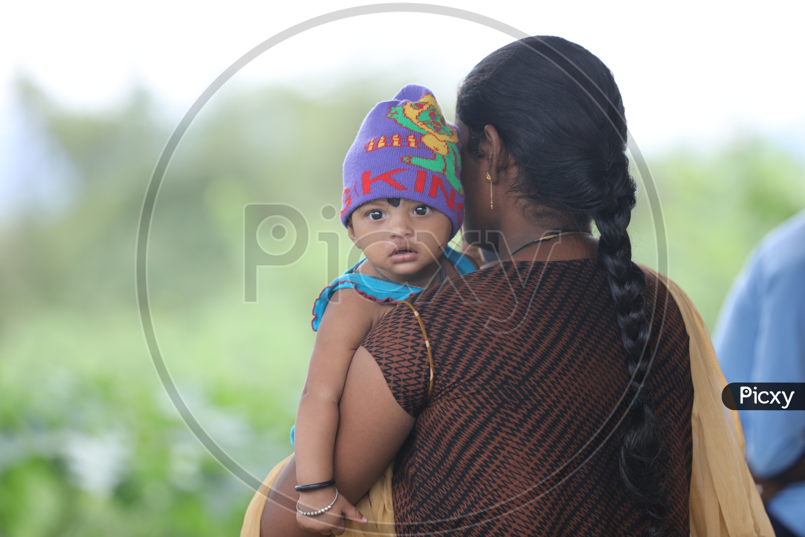 Indian Little babygirl on her Mother's Shoulders