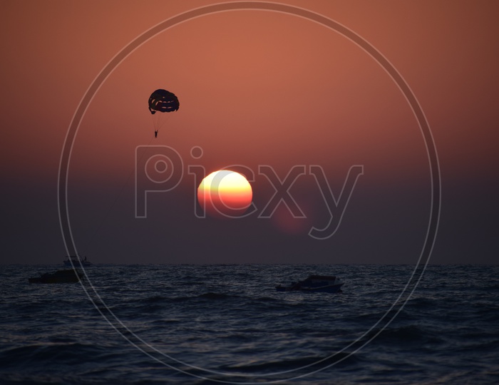 Paragliding during sunset at Candolim beach