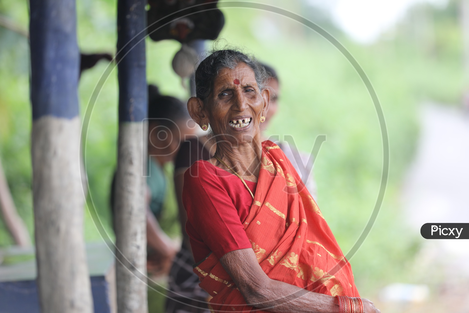 Indian Old Woman smiling with crooked teeth