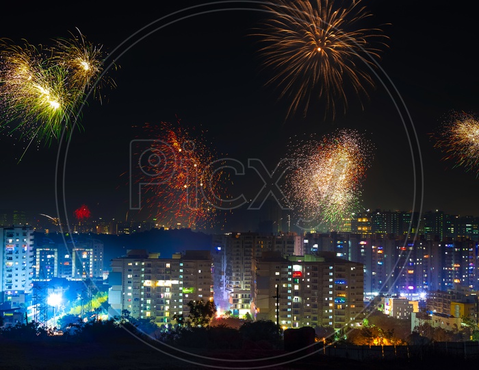Indian Festival Diwali Deepavali Celebrations In Hyderabad with Crackers bursting in the sky on top of high rise buildings