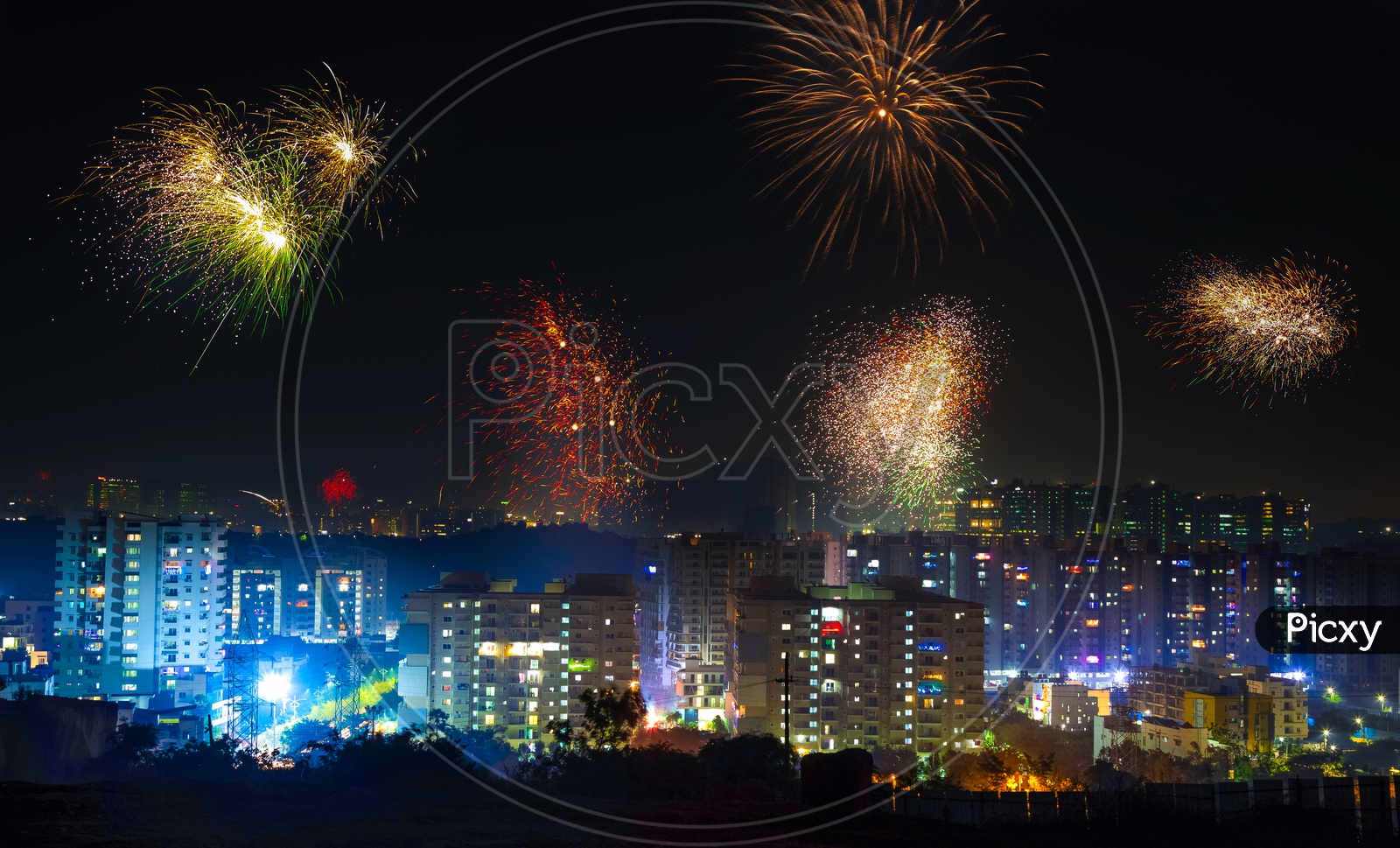 Indian Festival Diwali Deepavali Celebrations In Hyderabad with Crackers bursting in the sky on top of high rise buildings