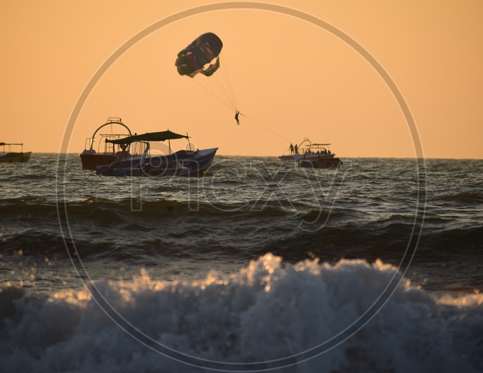 Paragliding during sunset at Candolim beach