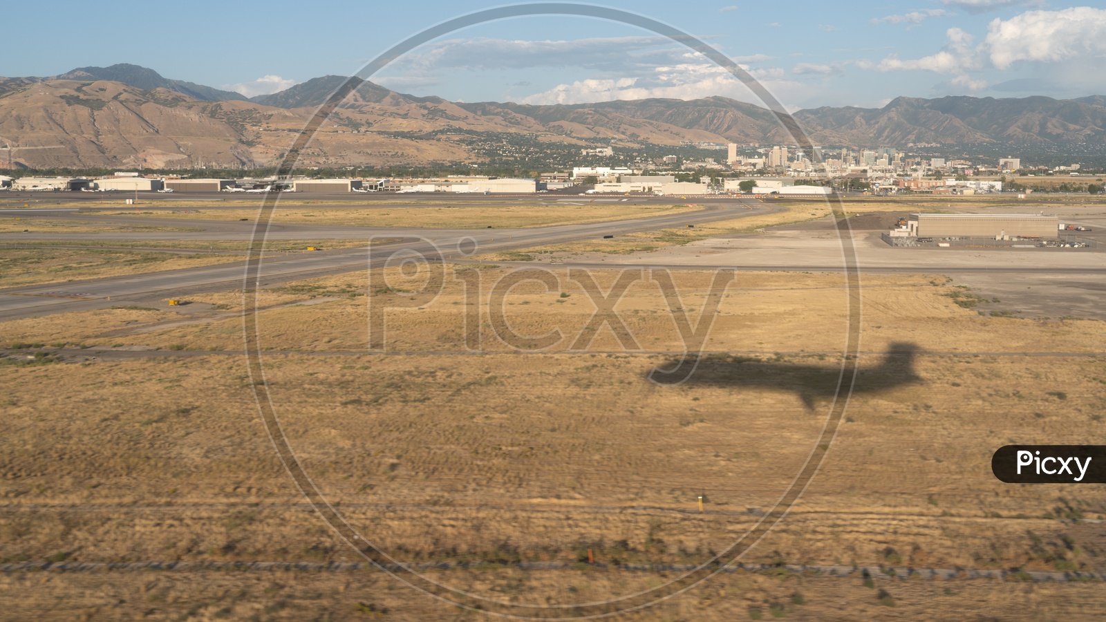 Aerial view of Shadow of Airplane against Wasatch Mountain ranges