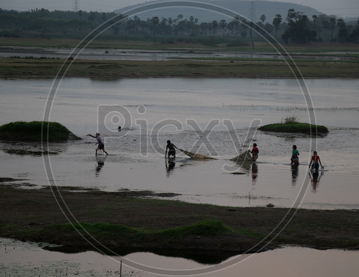 Woman Fishing In a Lake With  Sarees