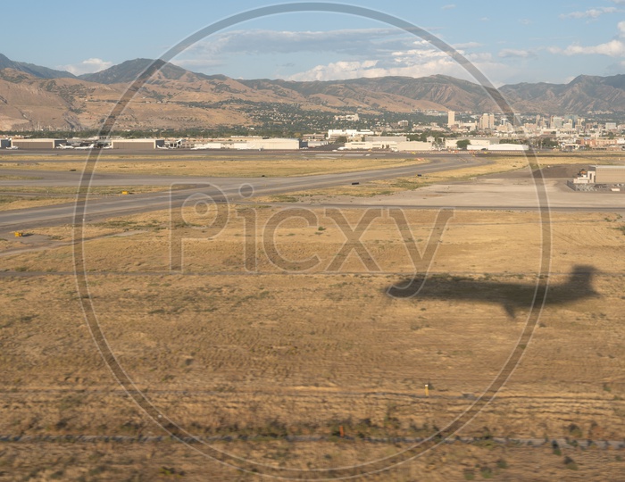 Aerial view of Shadow of Airplane against Wasatch Mountain ranges