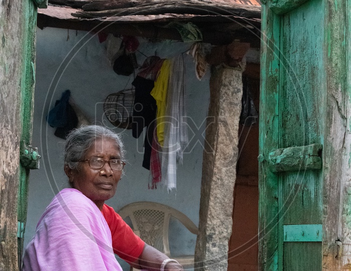 Grandmother Or An Old Woman Sitting At a House Door Step In an Indian Rural Village