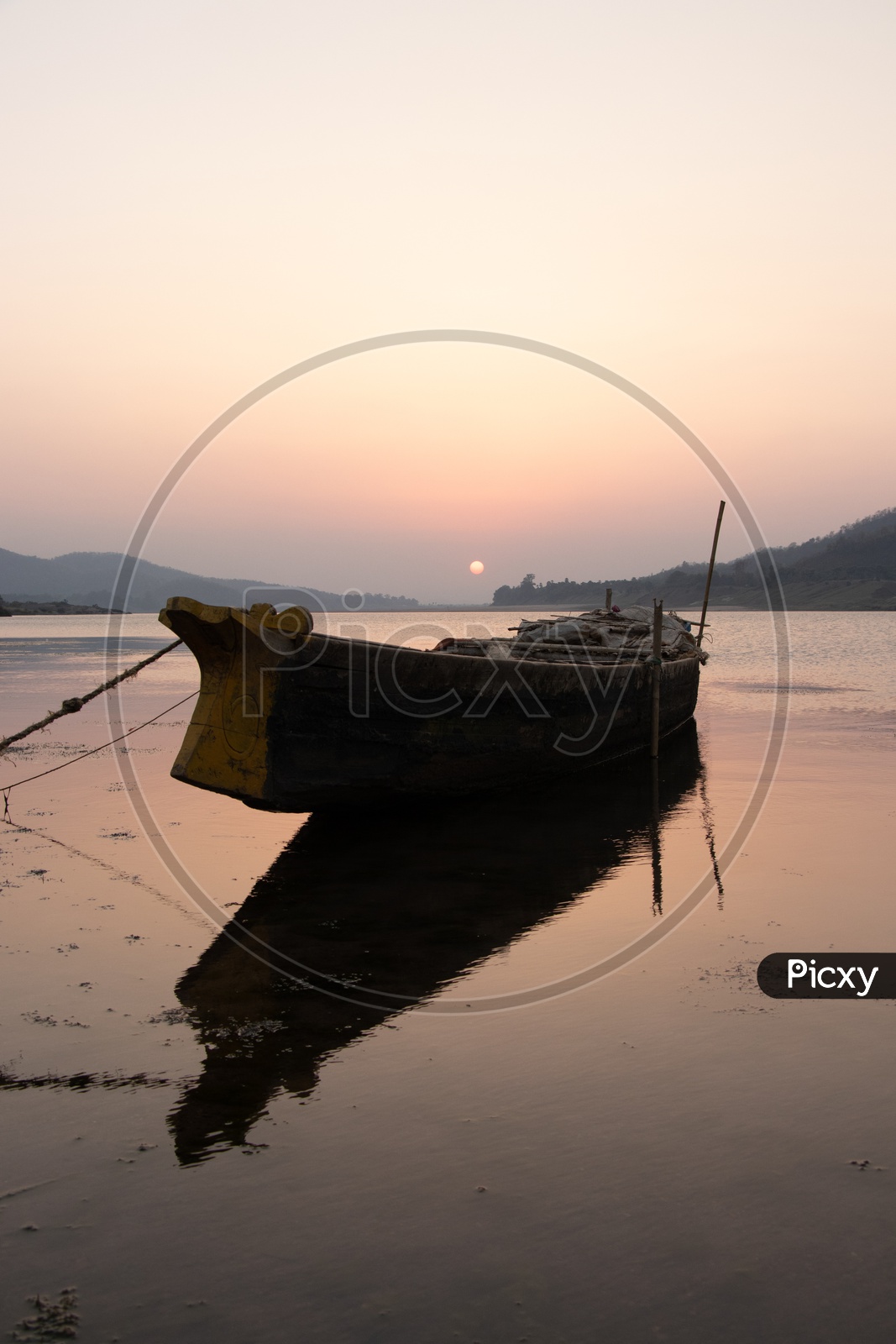 Lone Fishing Boat Anchored In Godavari river With Sunset Background