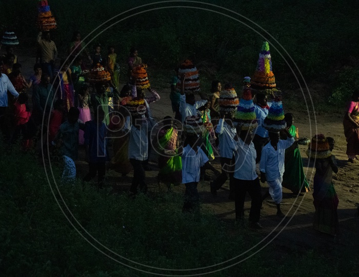 Bathukamma Festival Celebrations By People Carrying  Bathukamma Over Their  Heads