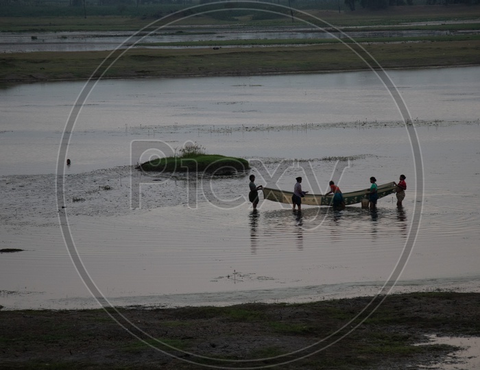 Indian Fisher Woman Fishing In a Lake Using Saree As Fishing  Net