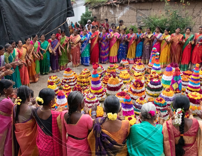 Telangana Woman Celebrating Saddula Bathukamma Festival By Singing Songs Around Floral  Placed In Middle At Rural Telangana Villages