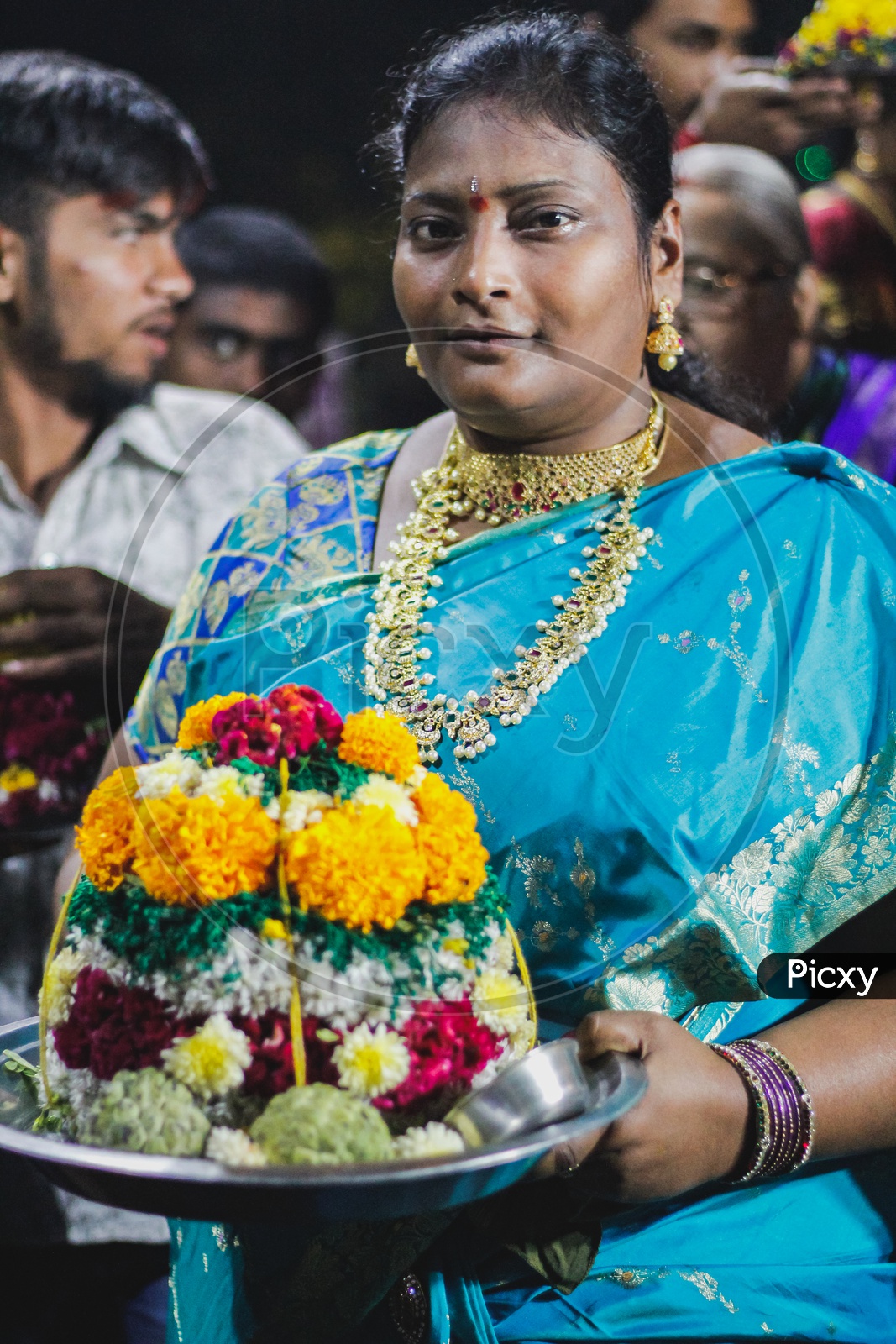 Woman posing with her Bathukamma.