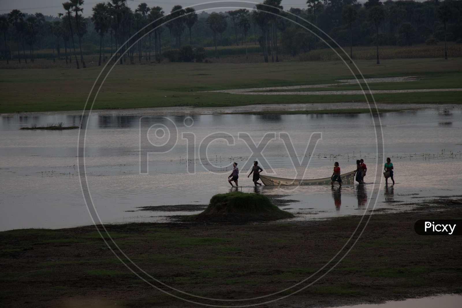 Woman Fishing In a Lake With Their Sarees