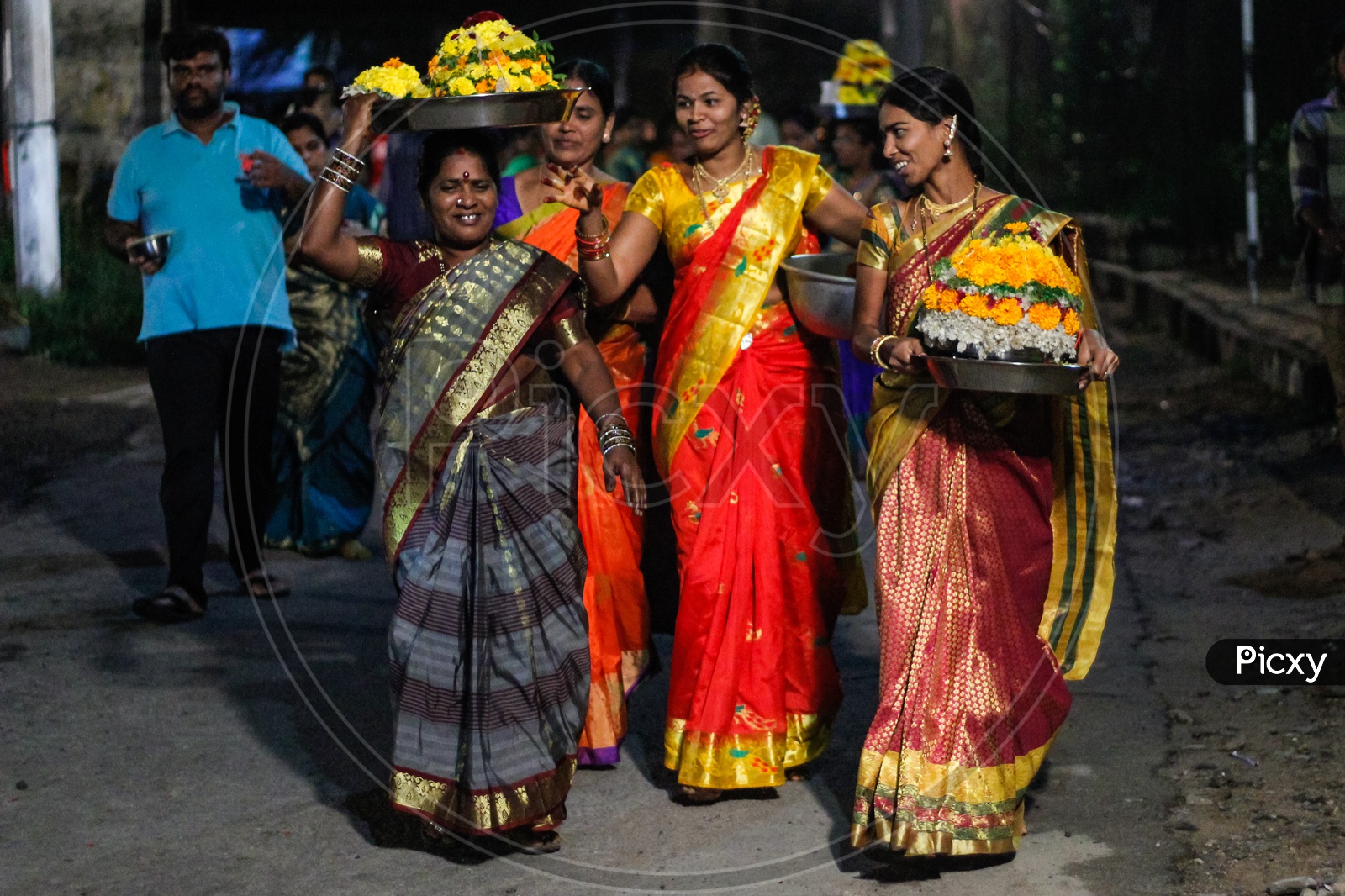 Women walking with their Bathukammas.