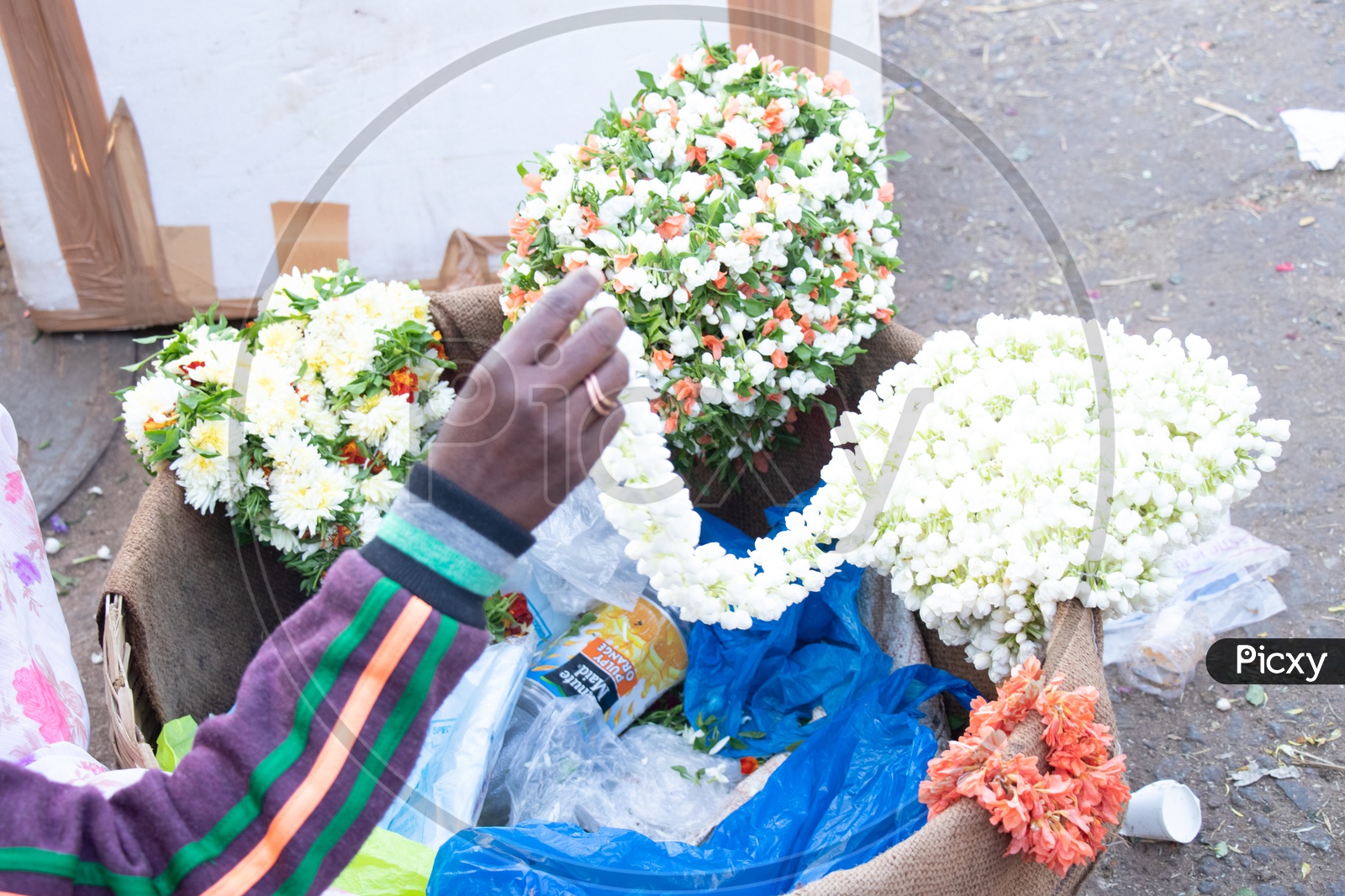 Woman Vendor With Flower Garlands Basket At a Flower Market