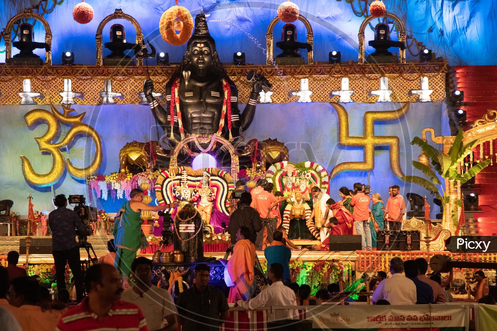 Hindu Priests Performing Pooja To Lord Shiva Linga on Stage At Koti Deeposthavam Event