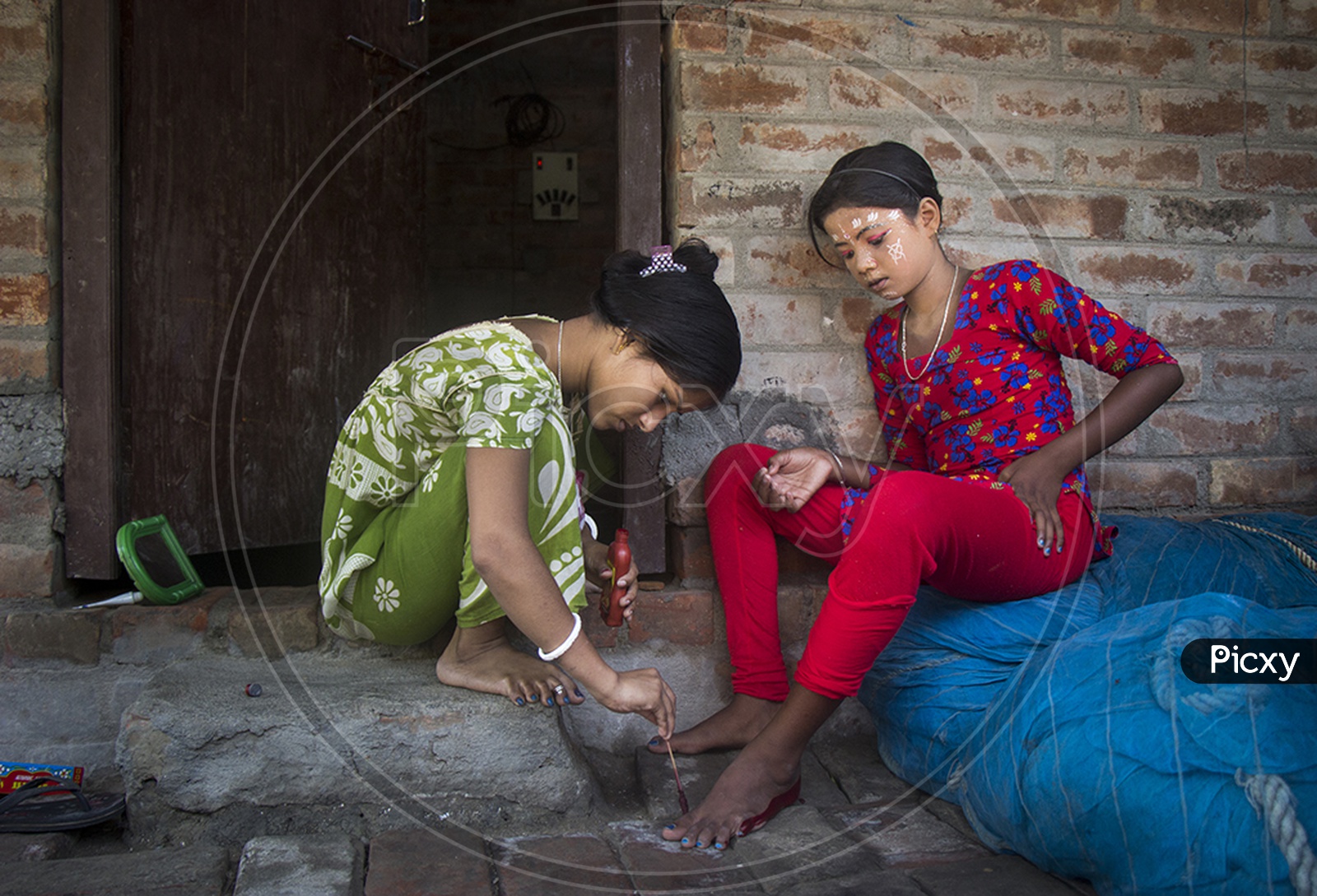 Indian Girls Putting On Red Ink To Feet