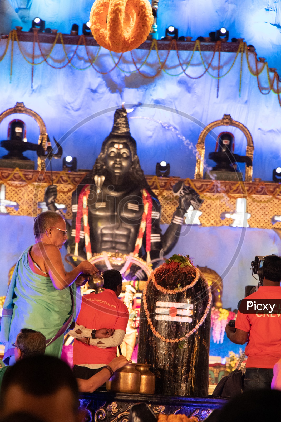 Hindu Priest Performing Pooja To Lord Shiva Linga At Koti Deeposthavam Event