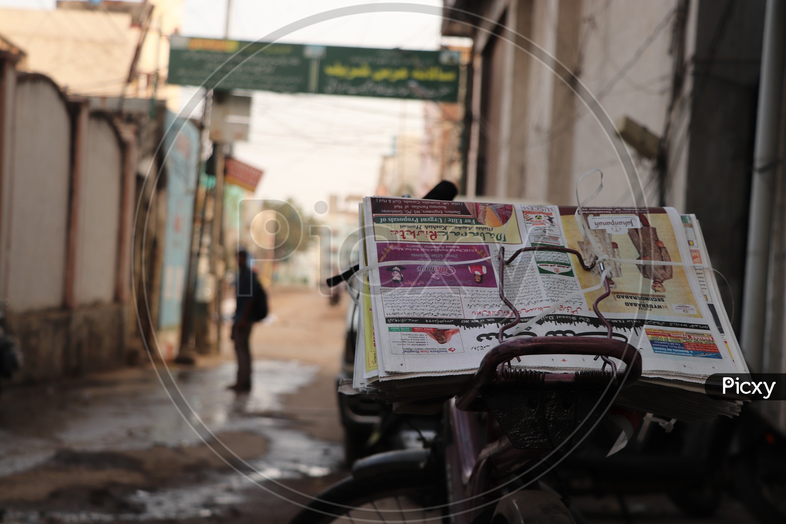 Daily Urdu Newspaper On a Cycle Back Of a Paperboy Around The Streets of Charminar