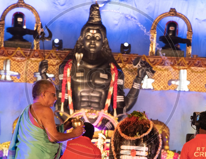 Hindu Priest Performing Pooja To Lord Shiva Linga At Koti Deeposthavam Event