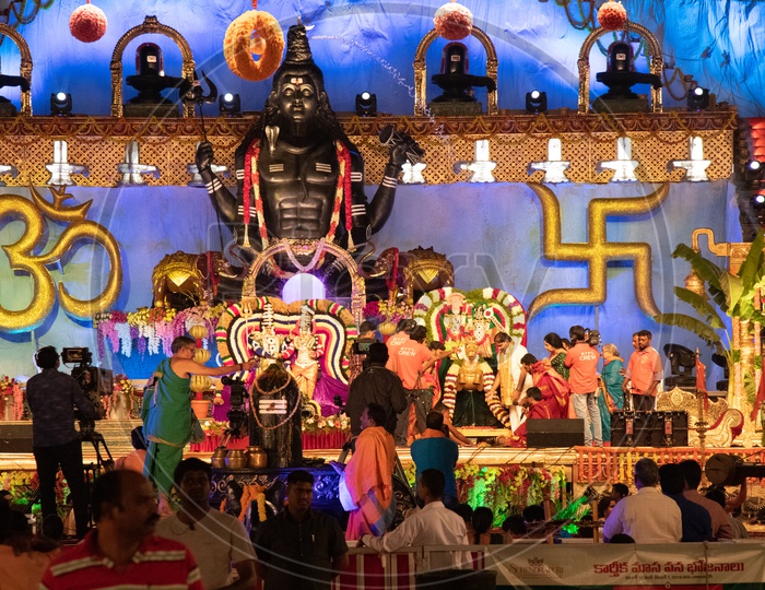 Hindu Priests Performing Pooja To Lord Shiva Linga on Stage At Koti Deeposthavam Event