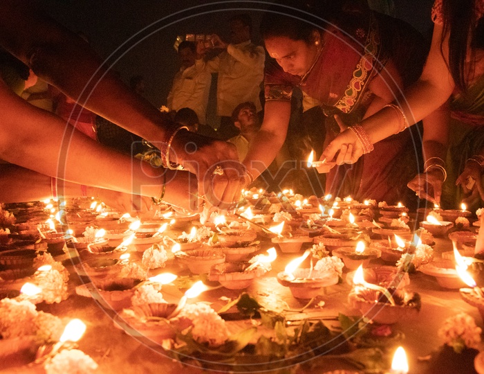 Image of Hindu Devotees offering Prayers To Lord Shiva By Lighting Dias