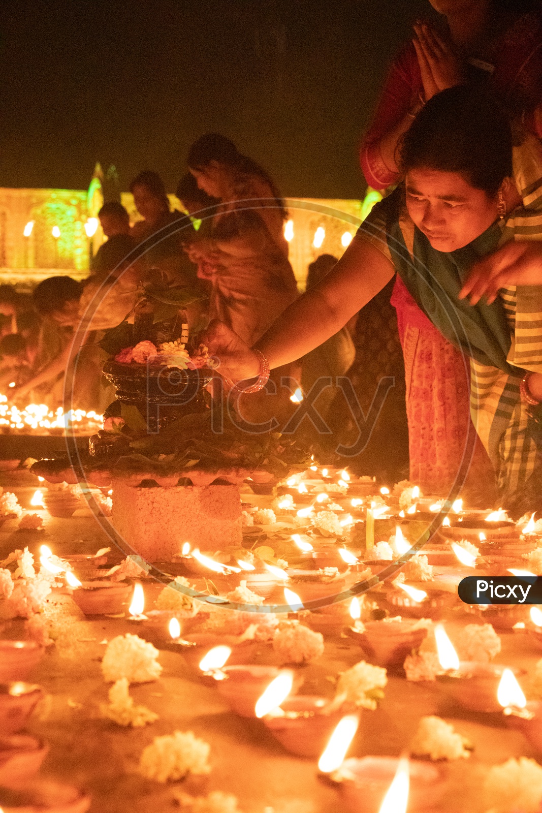 Hindu Devotees offering Prayers To Lord Shiva By Lighting Dias At Koti Deeposthavam Event in Hyderabad