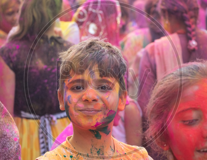 Indian Children Filled in Holi Colors Celebrating Holi Festival