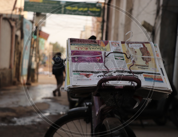 Daily Urdu Newspaper On a Cycle Back Of a Paperboy Around The Streets of Charminar