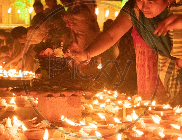 Hindu Devotees offering Prayers To Lord Shiva By Lighting Dias At Koti Deeposthavam Event in Hyderabad