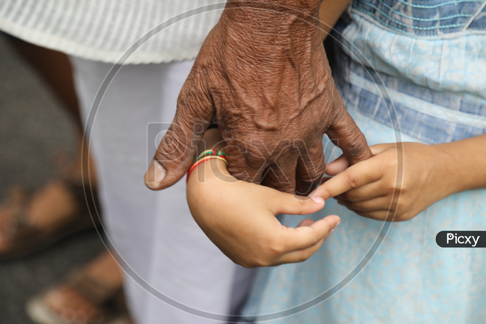 A Child holding his father's hand