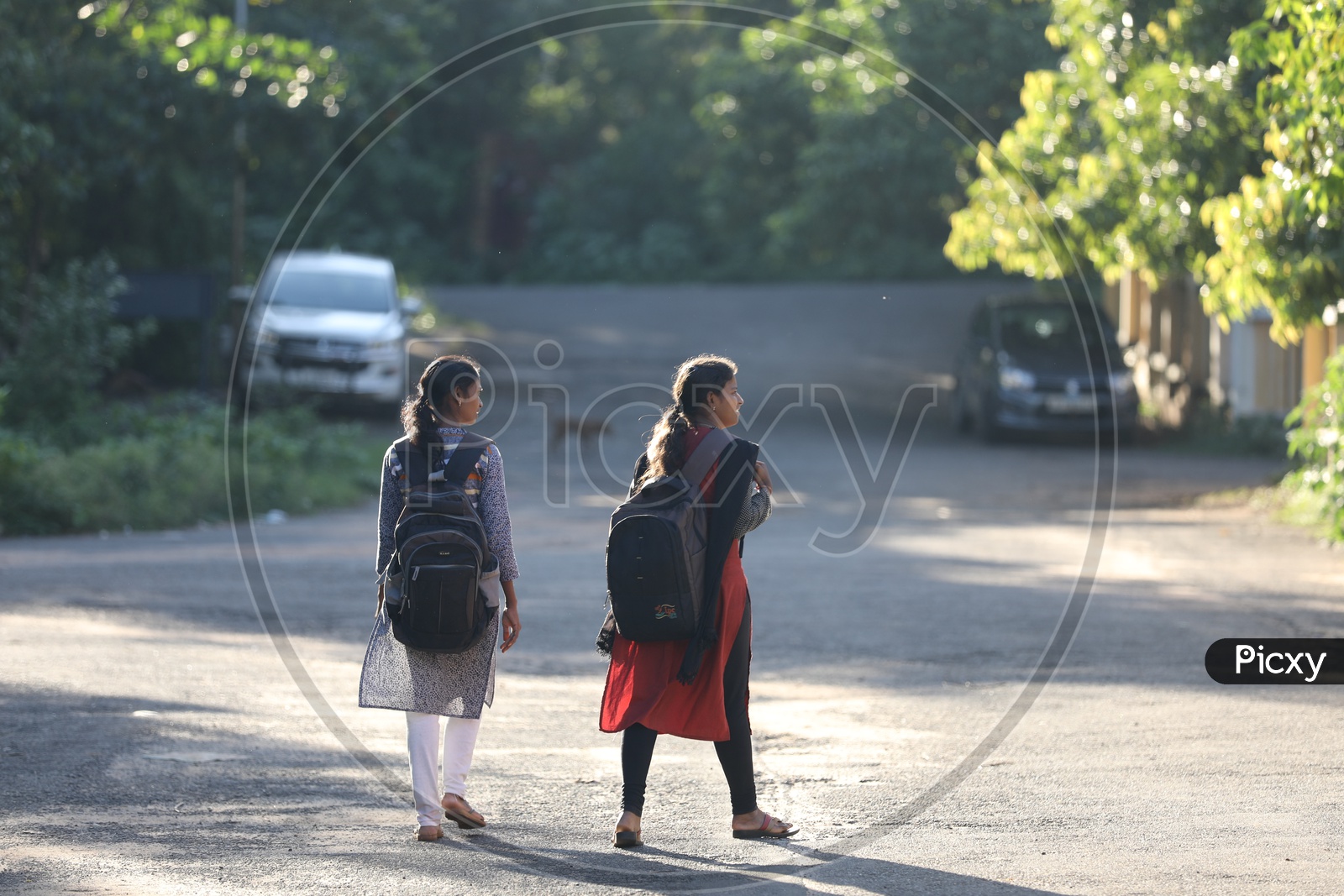 Two college girls carrying backpacks