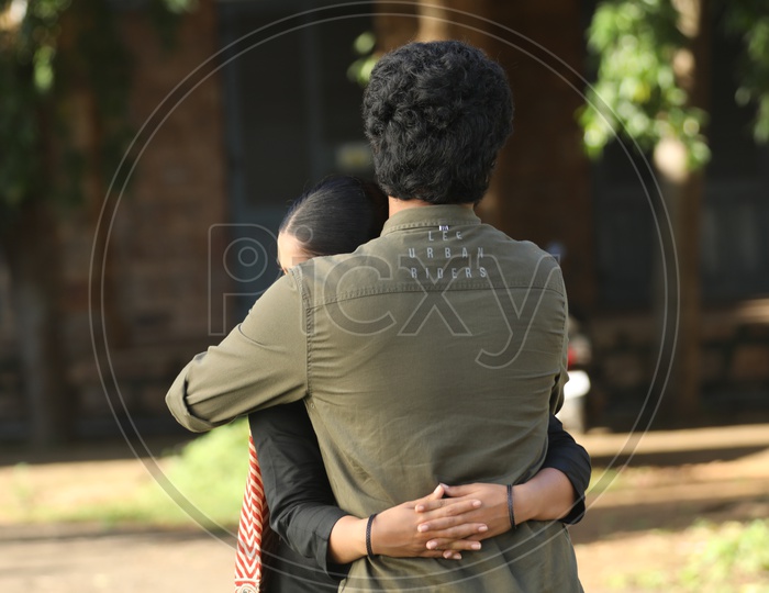 Indian Man hugging a girl in the college