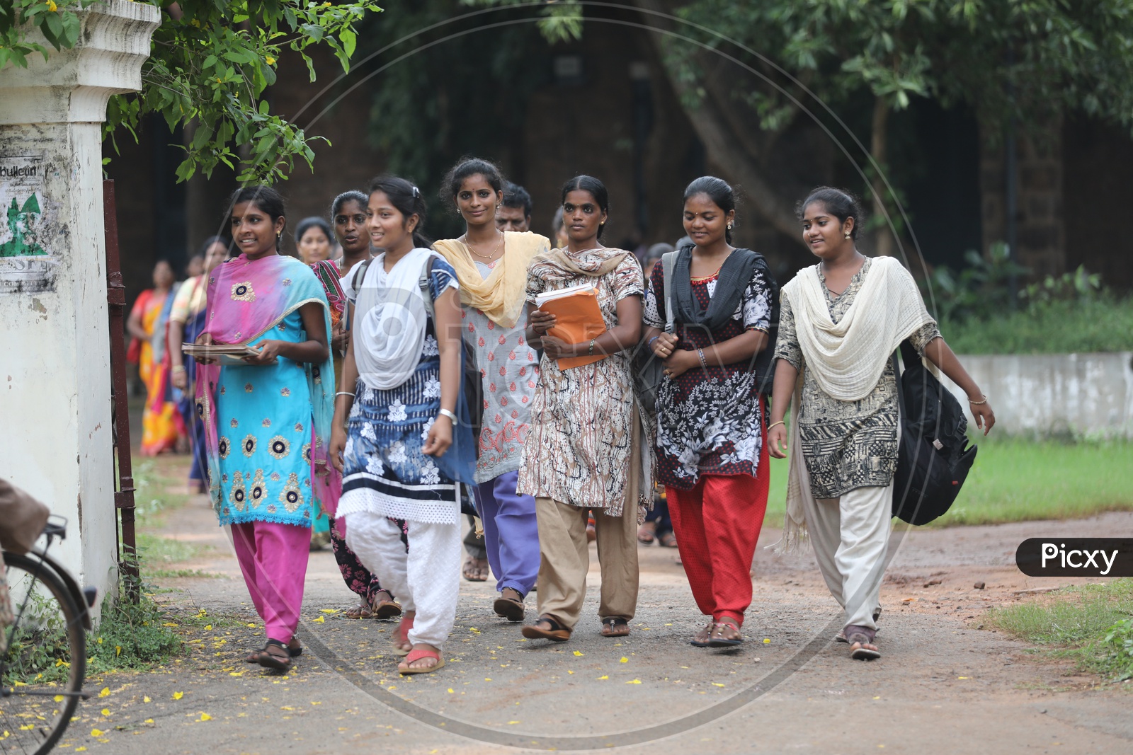 Group of Indian College girls walking holding books