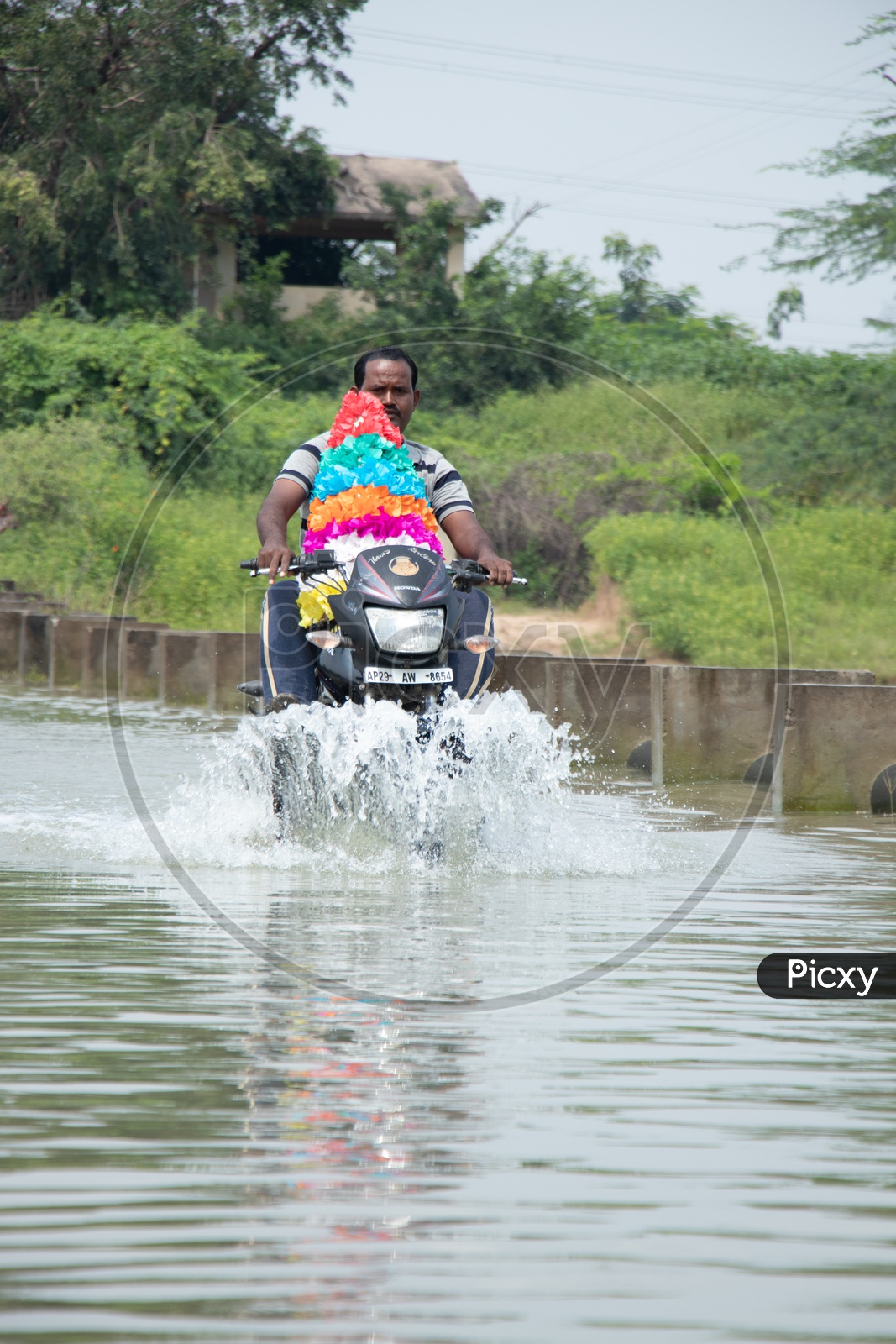 Man Carrying Bhathukamma On Bike And Crossing Flooded  Bridge  At Rural Village Of Telangana