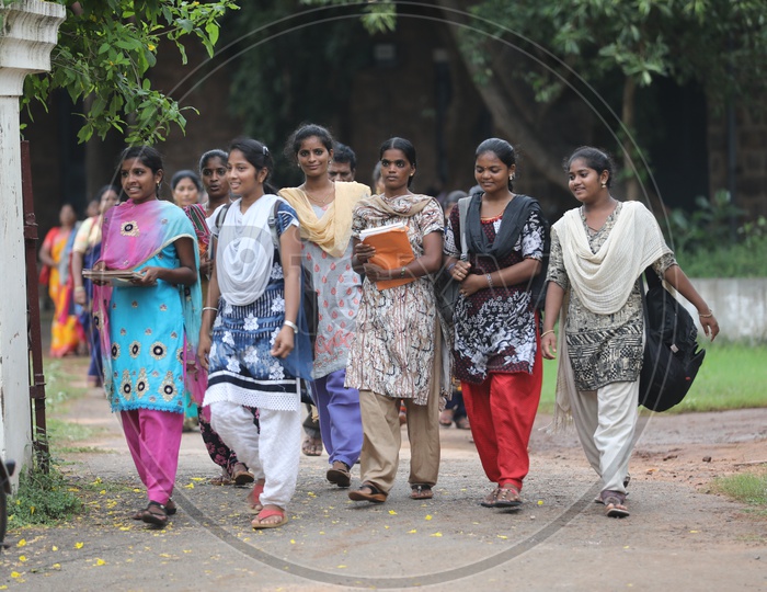 Group of Indian College girls walking holding books