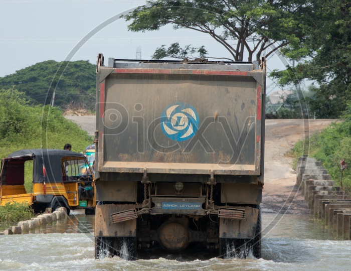 Truck  Tyre Closeup With Water Splash Crossing The Flooded Bridge